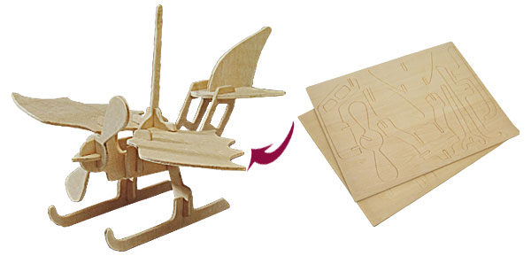 Wooden seaplane-style model with a propeller and twin floats beside a sheet showing its cut parts.