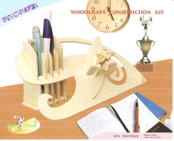 Boat shaped wooden desk organizer holding pens beside a small clock