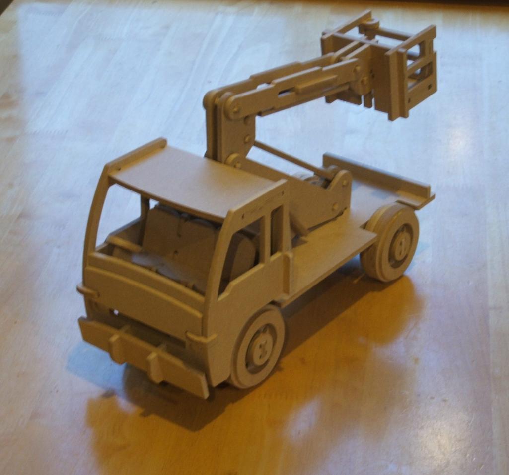 A wooden cherry picker truck carries a raised articulated boom and an open work basket.