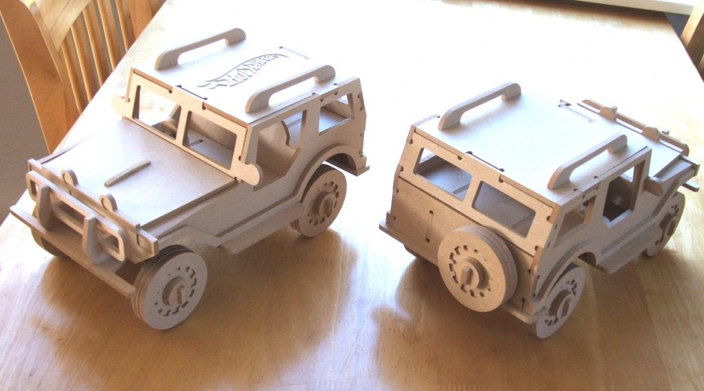 Two slotted wooden off-road truck models