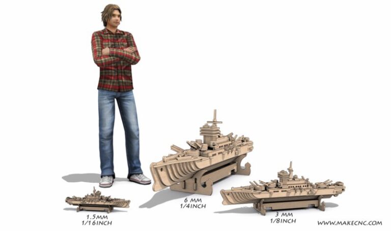 Two assembled slotted warship scale models displayed beside a standing person