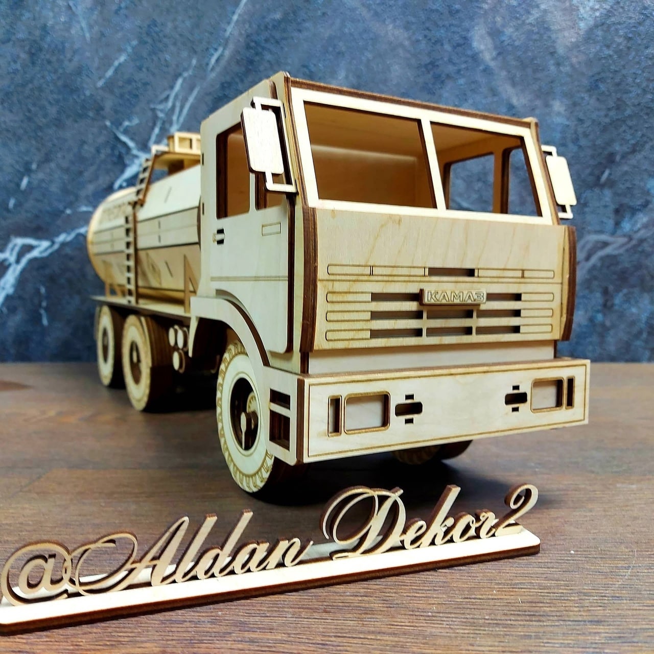 Wooden tanker truck model opened to reveal a wine bottle and glasses