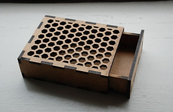 Small wooden card box with a honeycomb top and an open sliding tray