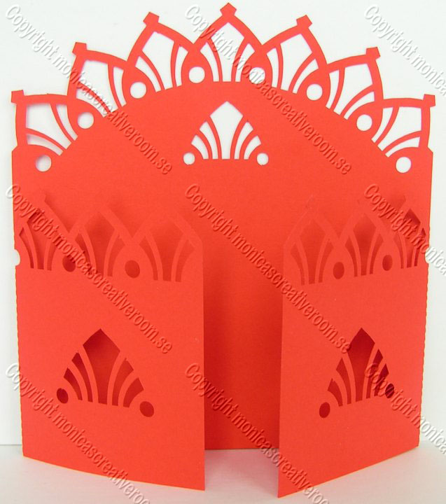 Red gatefold invitation with pointed petal cutouts and a tall decorative crest