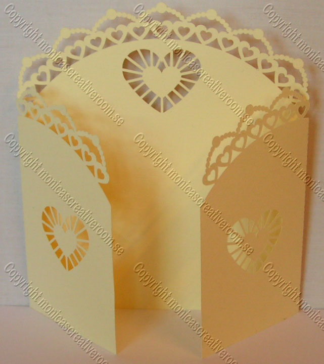 Gold gatefold invitation with pierced heart borders and fan-shaped heart details