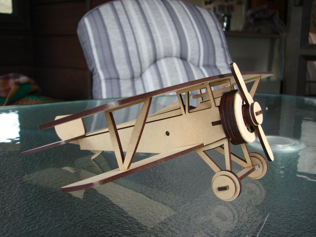 Wooden biplane puzzle model with paired wings, struts, front propeller and landing wheels