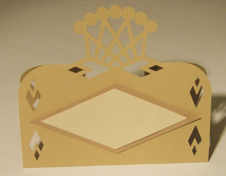 Gold place card with a heart-tipped lattice crest and diamond name panel