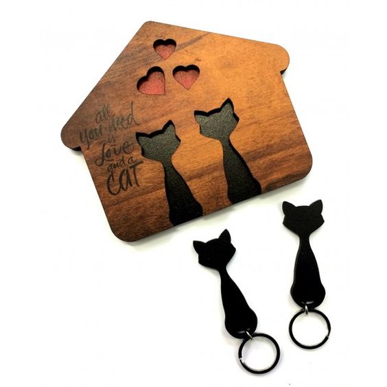 House-shaped wooden wall key holder with two removable cat silhouette key fobs