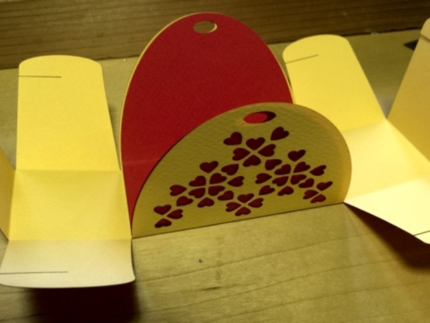 Open folding gift box with rounded handles and a cluster of heart cutouts