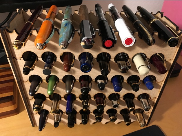 Wooden rack holding many pens horizontally in scalloped slots across several rows